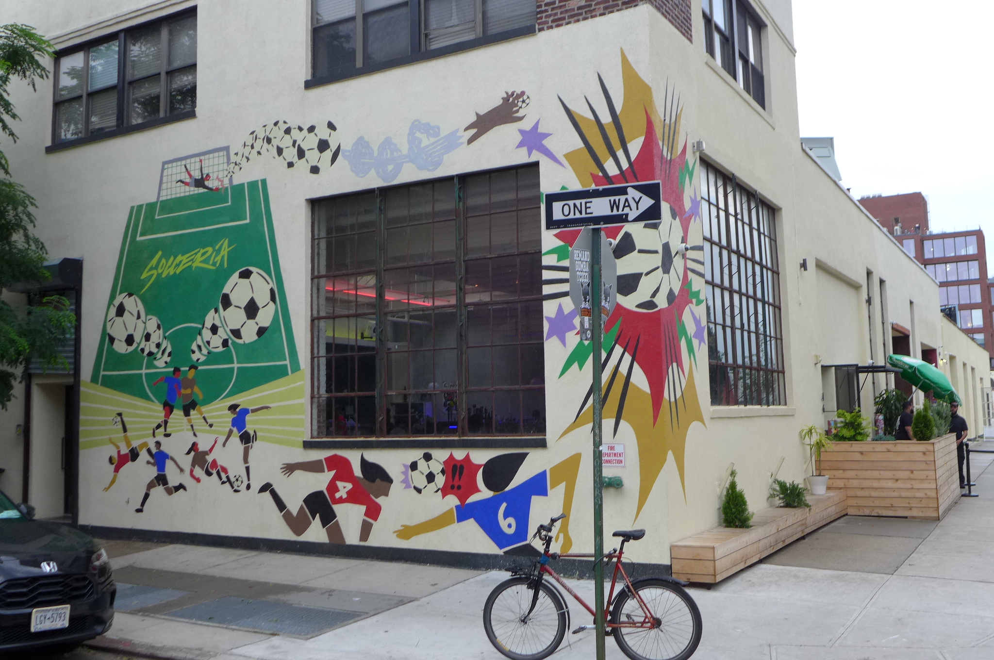 The exterior of a restaurant with soccer-themed street art