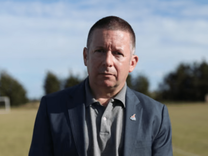Howard Beckett looking a bit glum posing for a photo outdoors on a field in 2021
