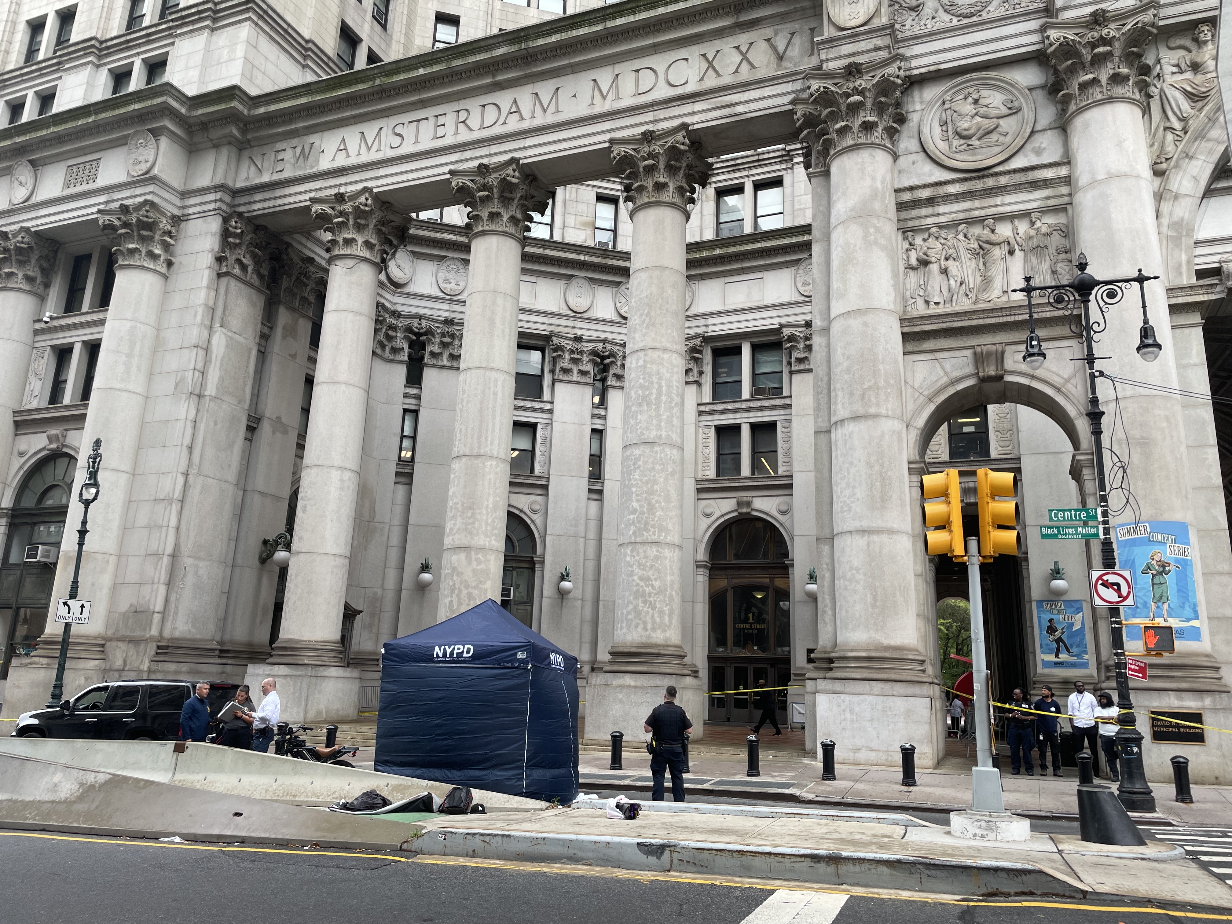 A blue tent near the Municipal Building where a teen died on an electric motorcycle.