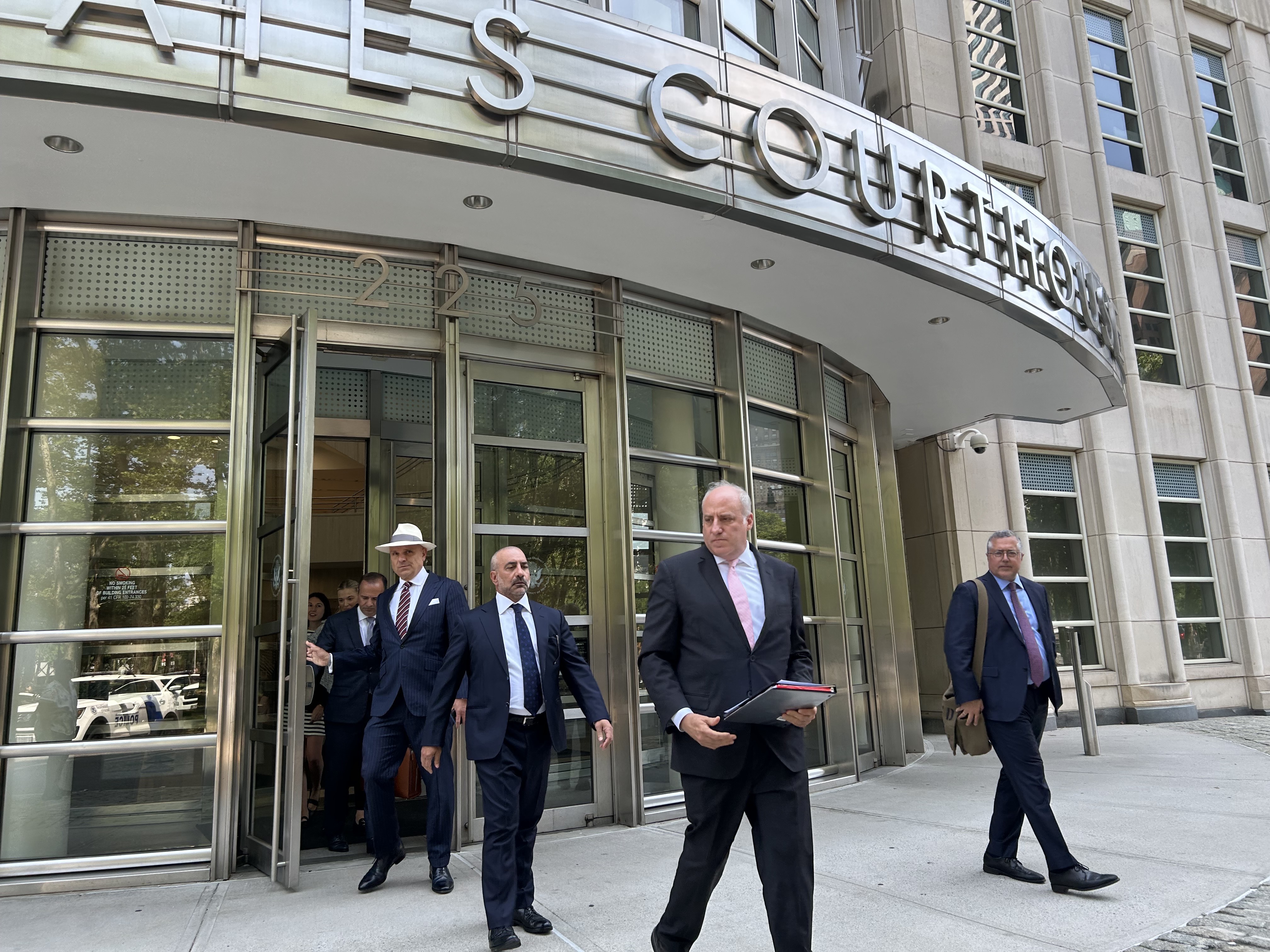 Frank Carone, second from left, leaves the federal courthouse in Brooklyn with some of his defense attorneys, during an appearance in July.