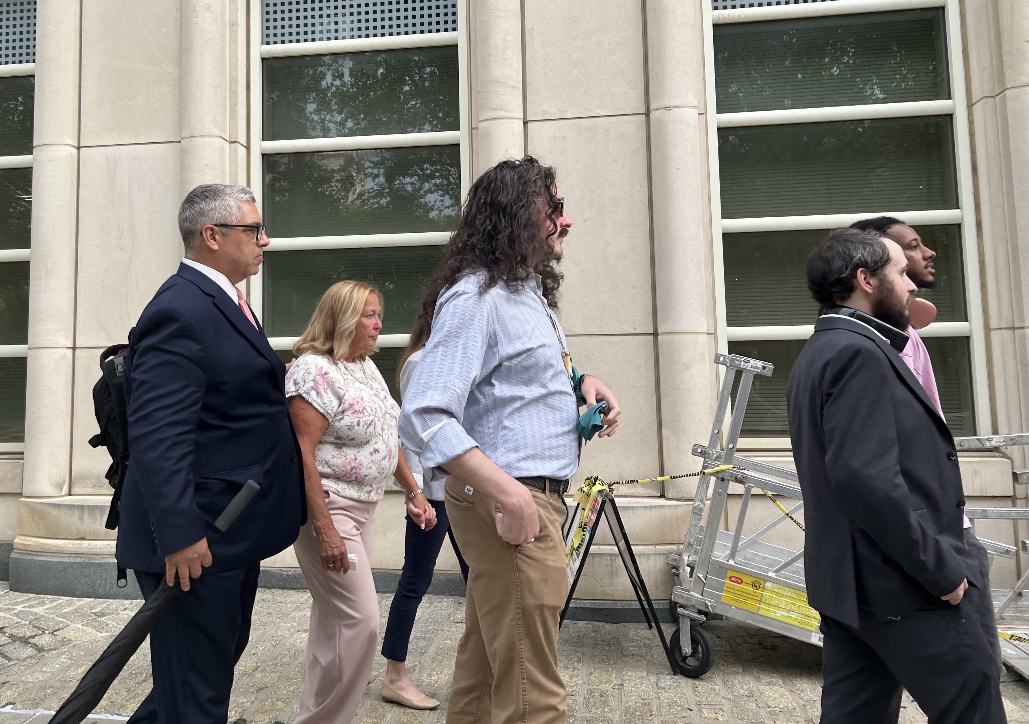 Lori Zeno, second from left, leaves the federal courthouse in Queens with her attorney and loved ones on Tuesday.