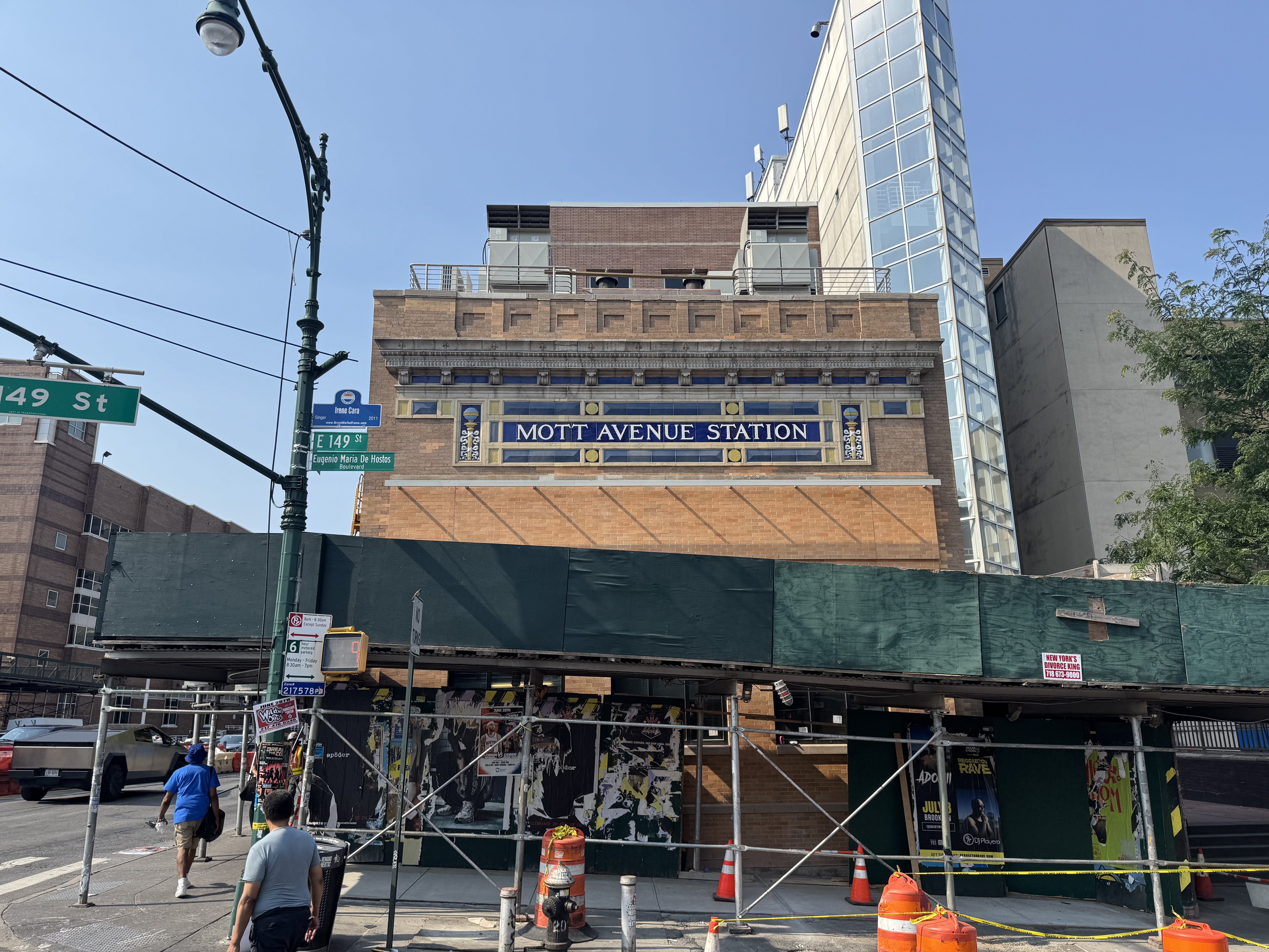 A station house with mosaics that say "Mott Avenue Station."