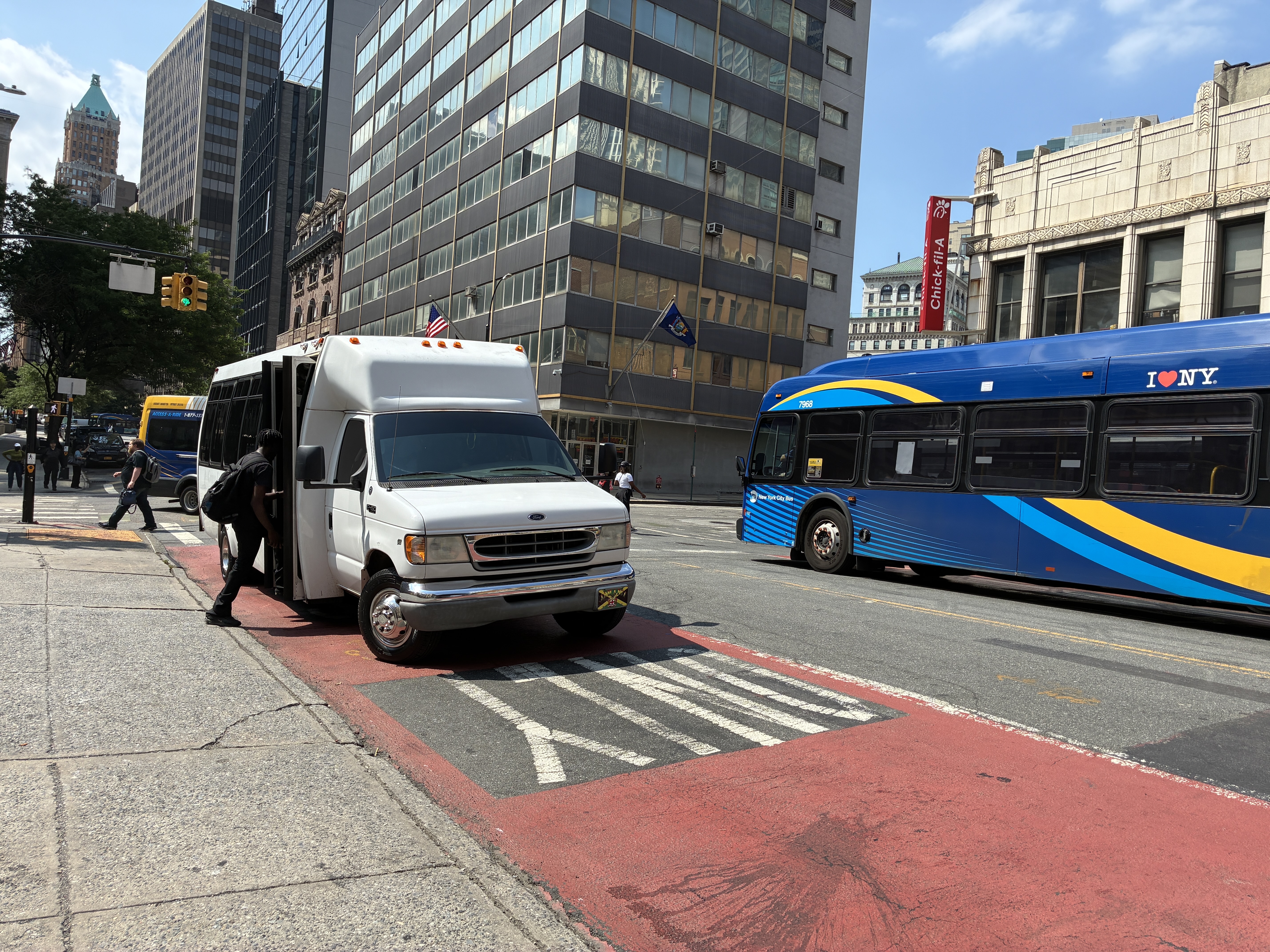 A small unlicensed van operates in a bus lane.