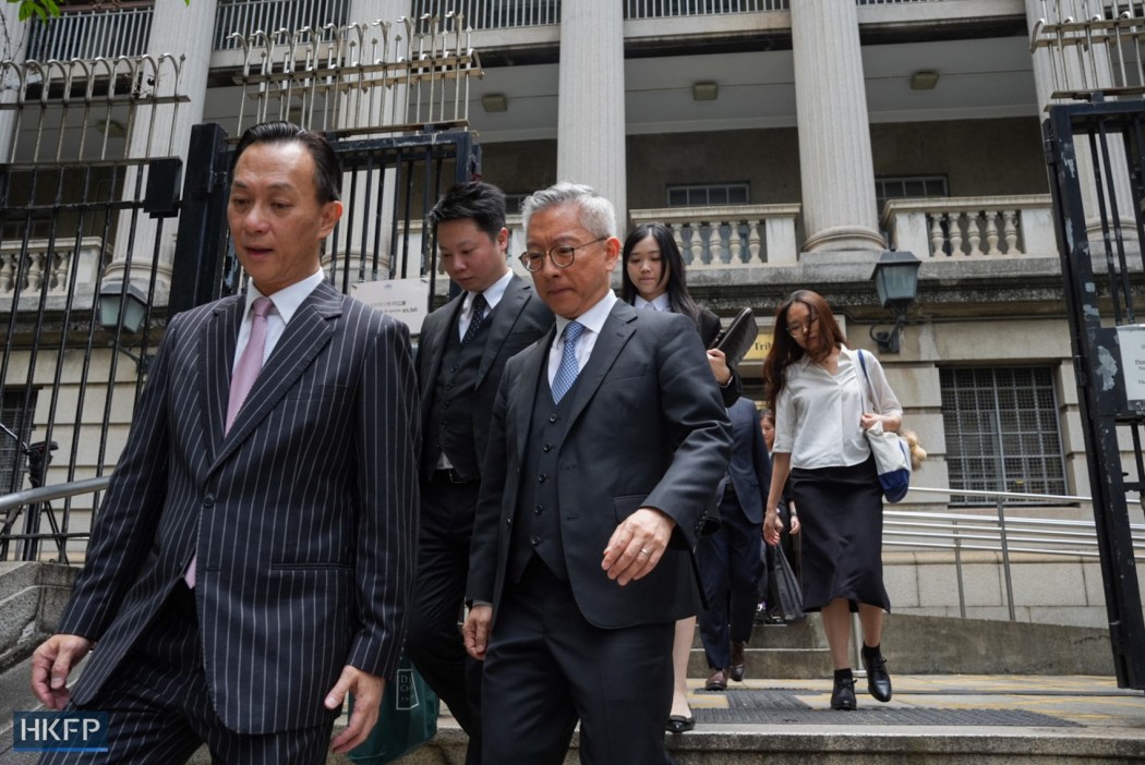 Hectar Pun (left), counsel for government-appointed administrator Hop On Management, leaves the Lands Tribunal on June 1, 2026. Photo: Kyle Lam/HKFP.