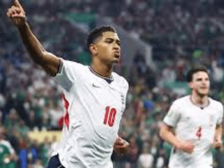 England player Jude Bellingham celebrates scoring their first goal with one hand in the air and his index finger making a 'number 1'