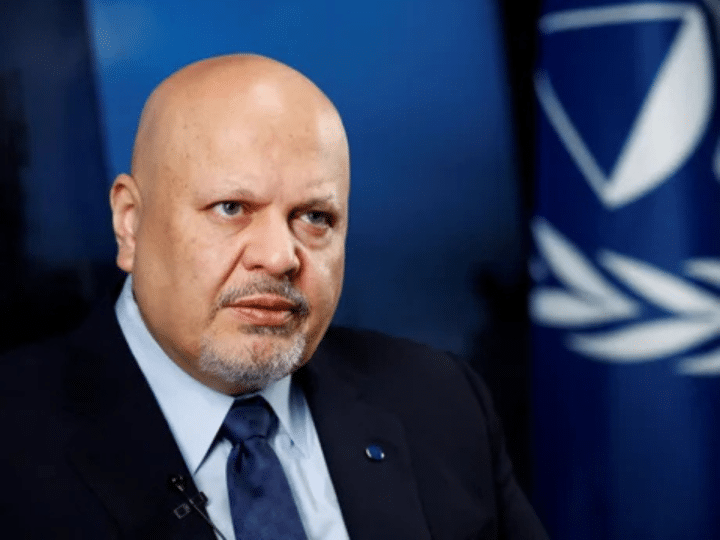 Karim Khan, ex-ICC prosecutor, who has a bald head and piercing eyes, looks stern as he stares into the distance