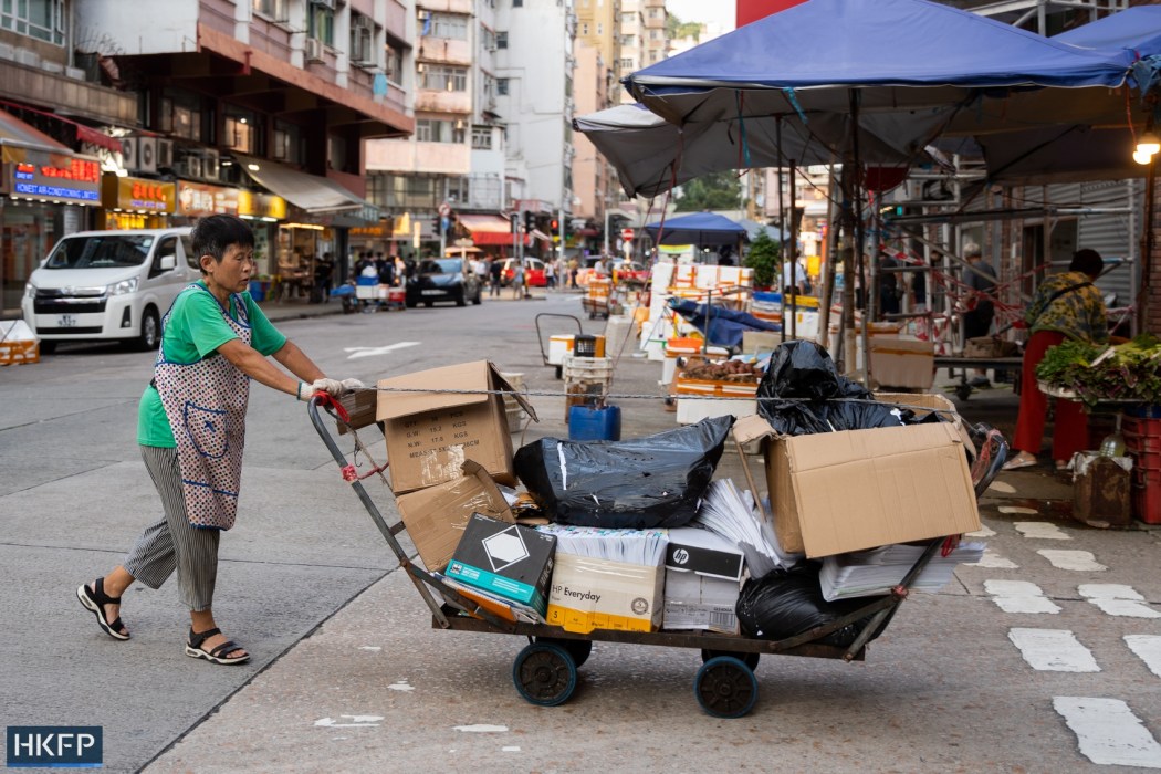 A woman pushes a trolley full of cardboard boxes in Hong Kong. File: Kyle Lam/HKFP.
