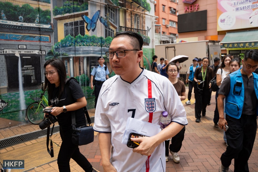 A Wang Fuk Court resident surnamed Chan leaves a flat owners meeting at Tai Po Community Centre on July 19, 2026. Photo: Kyle Lam/HKFP.