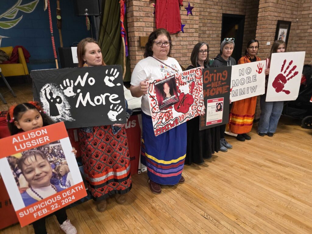 Friends and family members hold posters of missing and murdered Indigenous women and girls in Duluth, Minn., in February. A new report found American Indian and Alaska Native survivors of violence say reductions in federal funding have led to over 1,000 unmet requests for help. (Photo by Frank Zufall/Wisconsin Examiner)