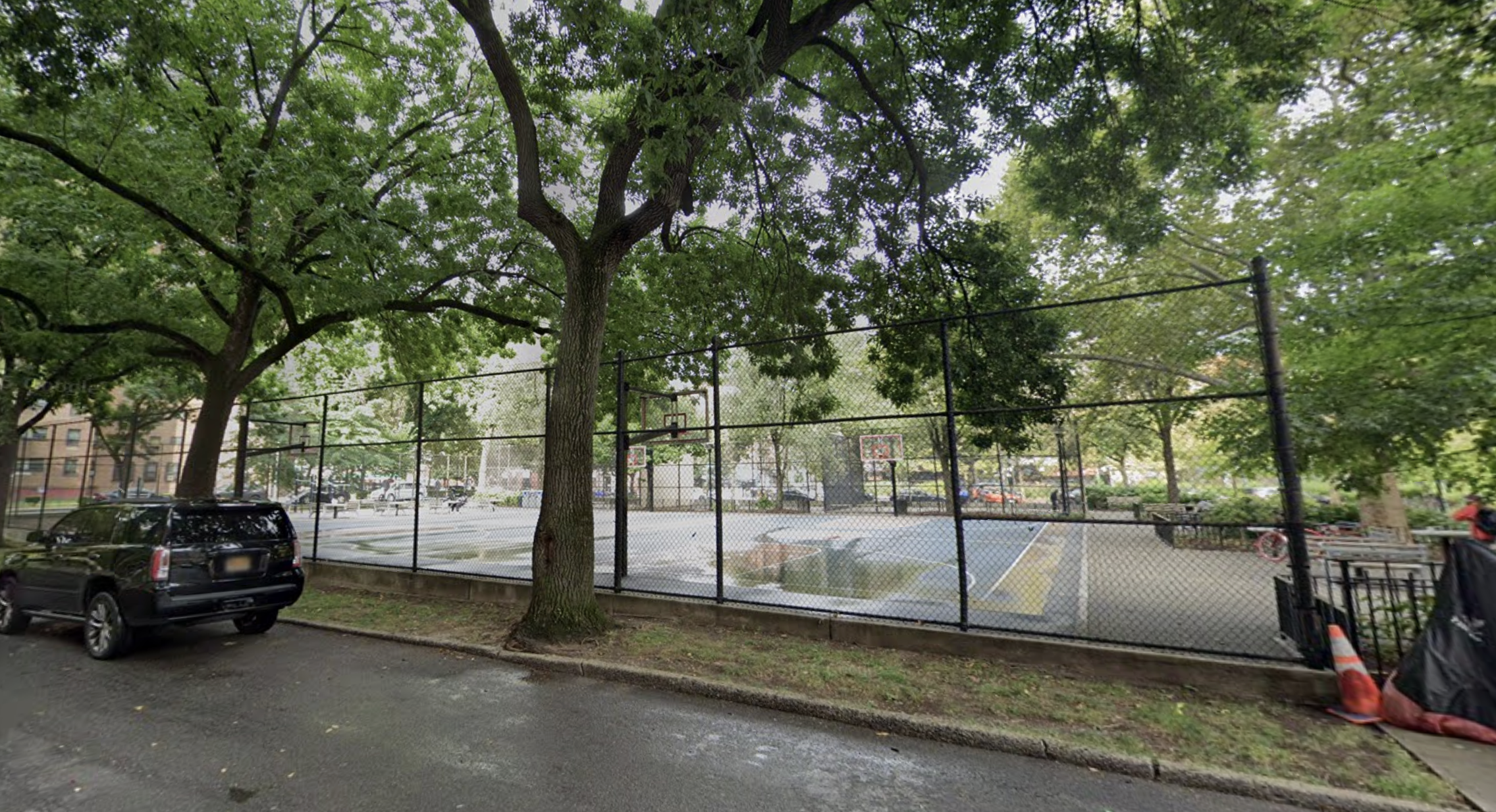 An image of a rainy basketball court in Harlem where police say a shooter killed one man and injured 2 others.