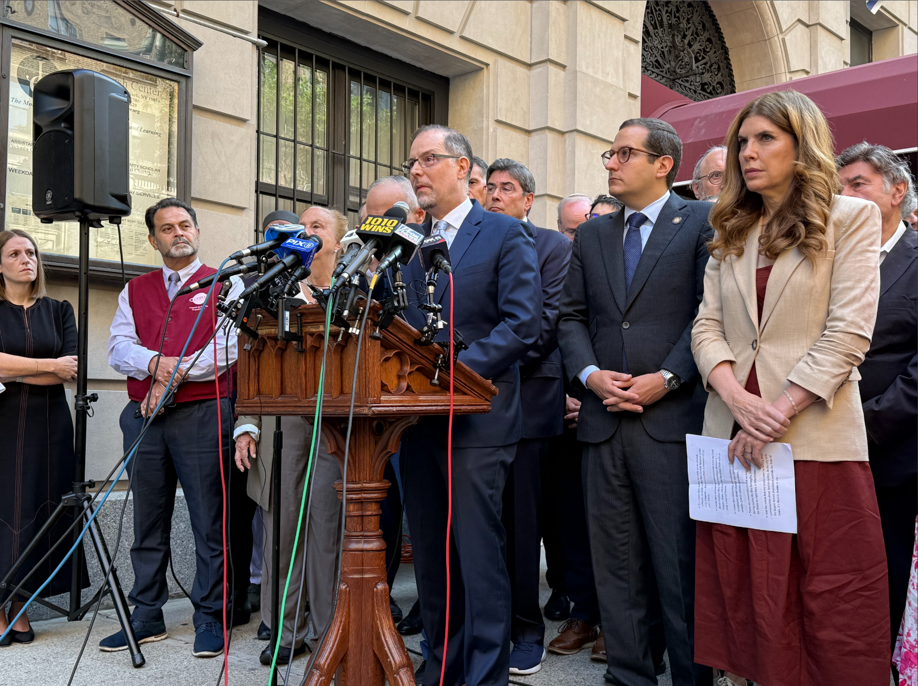 Mark Levine, Micah Lasher, Julie Menin and others at a press conference.