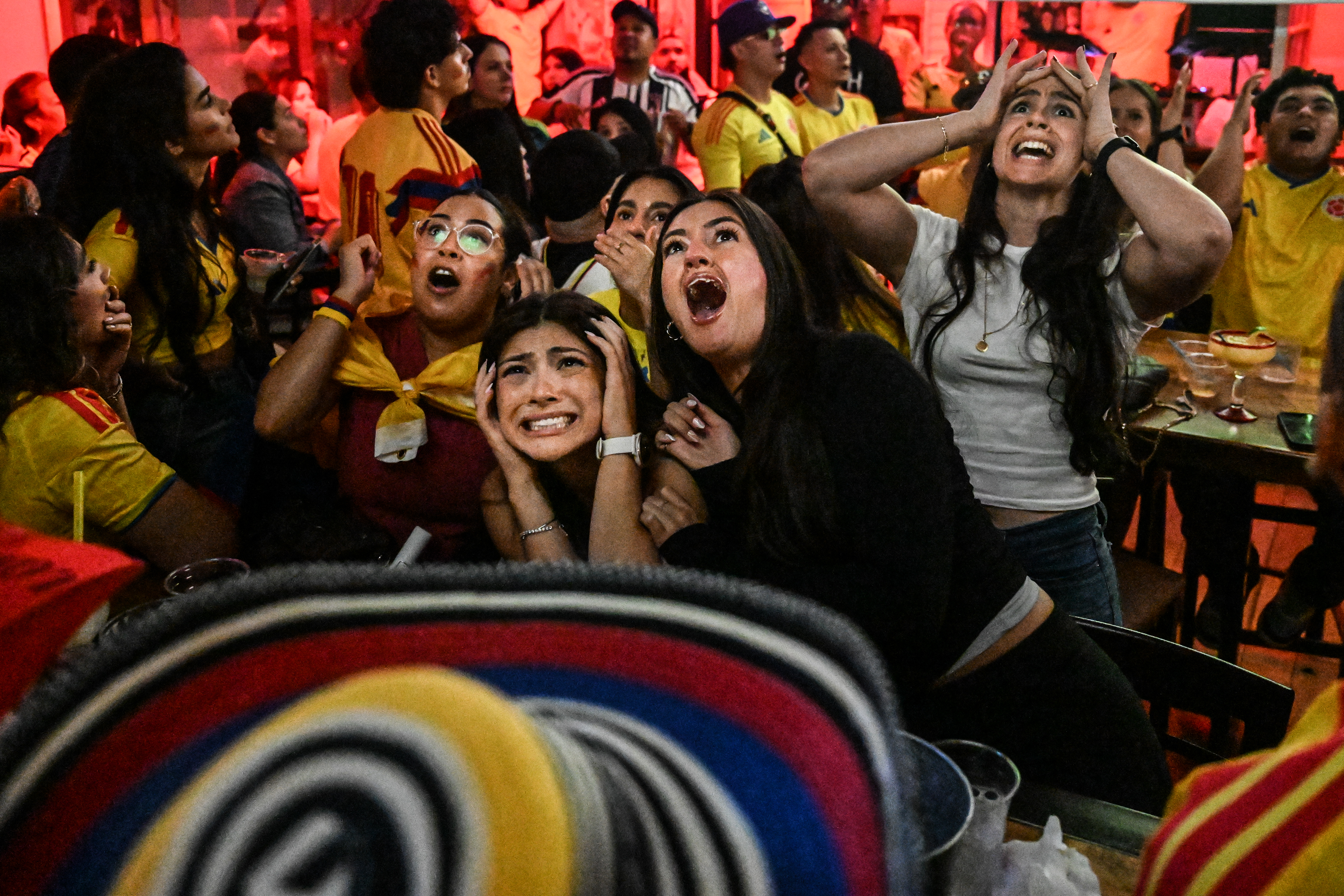 A group of people watching the World Cup at a bar.