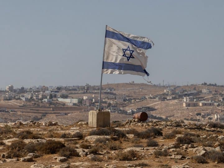 A tattered Israel flag flies near a West Bank settlement