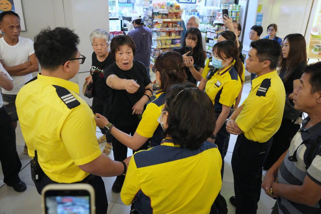 MTR staff take two women aside for questioning at Yuen Long MTR station on July 21, 2026. Photo: Supplied.