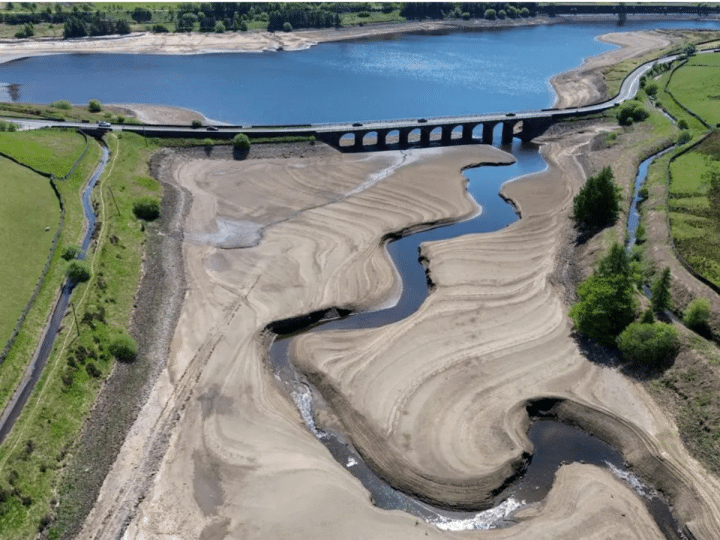 Woodhead Reservoir in Derby from above so you can see the grassy areas, windy water in the middle and the bank either side