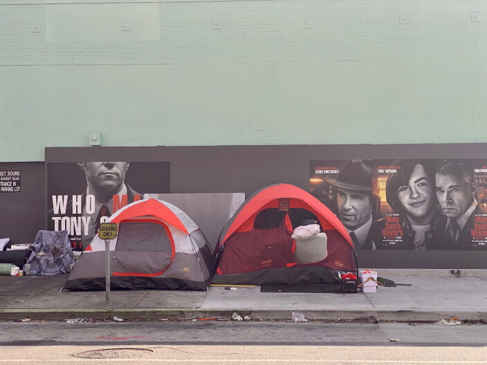 Two tents next to each other on a sidewalk.