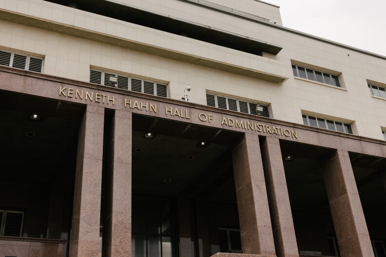 A large building with an entrance sign that reads "Kenneth Hahn Hall of Administration."