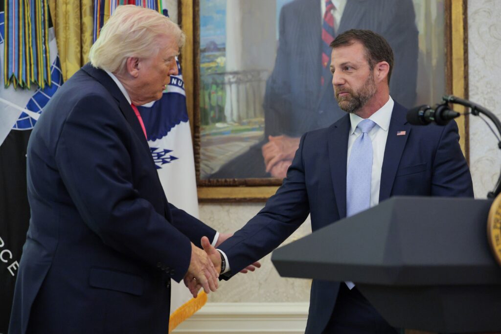President Donald Trump shakes hands with newly sworn in Homeland Security Secretary Markwayne Mullin during a ceremony in the Oval Office on March 24, 2026. (Photo by Chip Somodevilla/Getty Images)