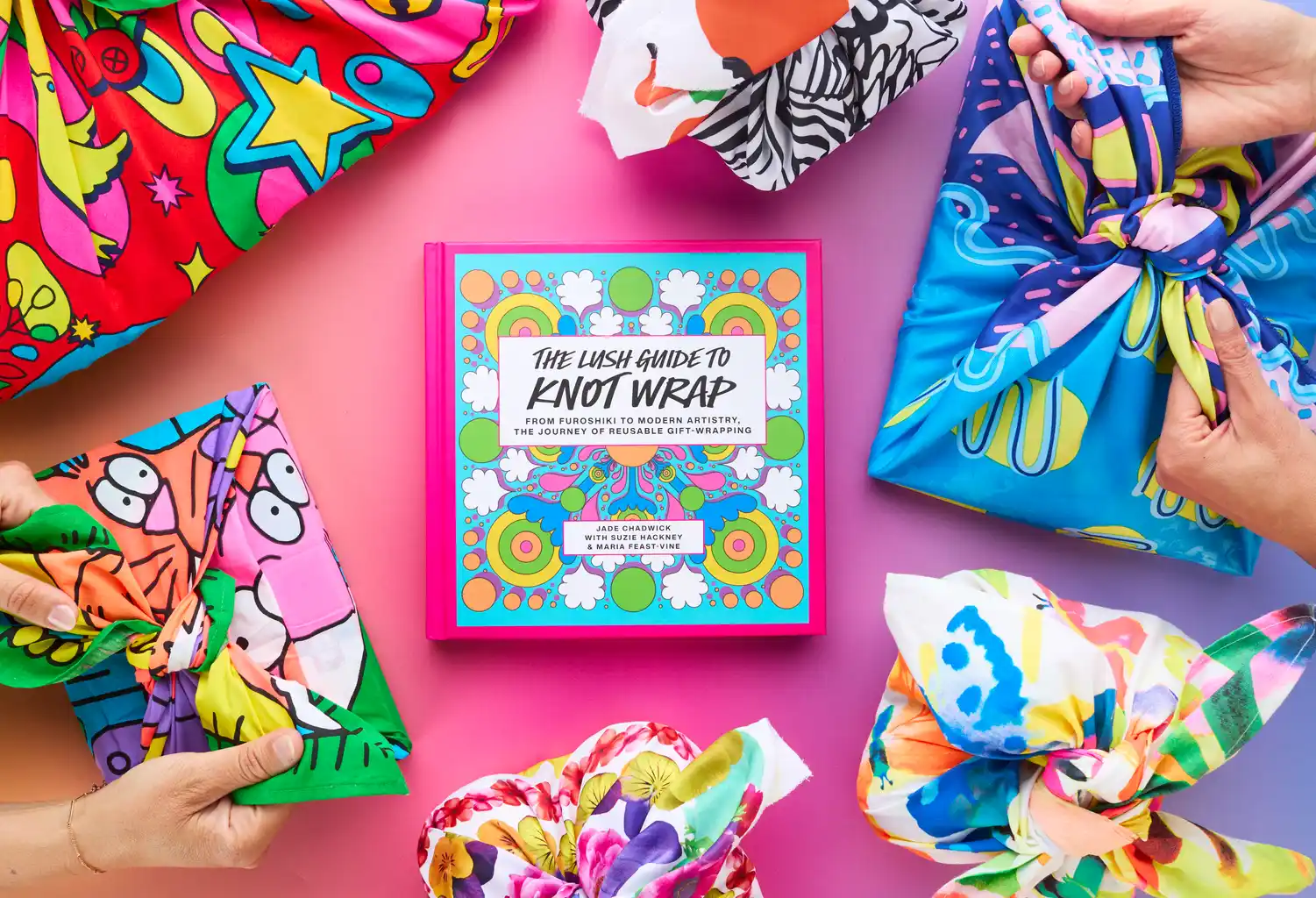 The book is in the middle of the image. Around it are gifts wrapped or being wrapped in an assortment of Knot Wraps of all different and bright colours