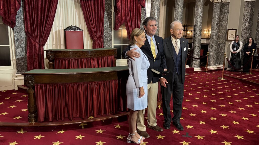 U.S. Sen. Darline Graham, left, Republican of South Carolina, participates in a reenactment of her swearing-in at the U.S. Capitol on July 14, 2026, alongside her husband, Larry Nordone, and Iowa GOP Sen. Chuck Grassley, president pro tempore of the Senate. (Photo by Shauneen Miranda/States Newsroom)