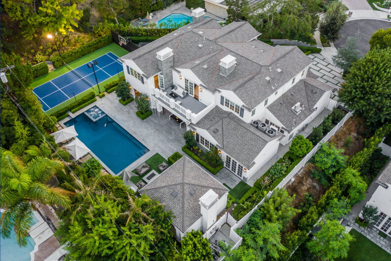 Massive home features a pool, pool house, tennis court and two stories of living space