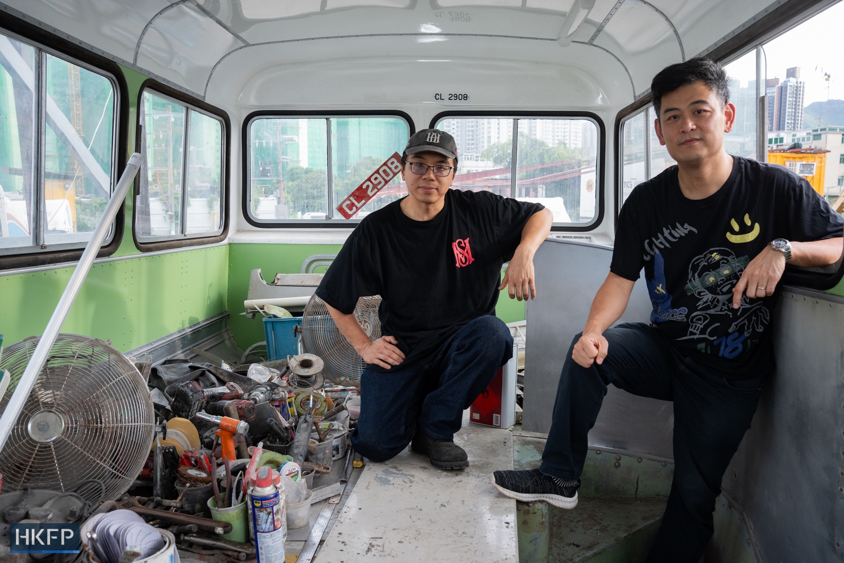 Chung (left) and Terrence with their Leyland Victory Mark II bus, which is undergoing restoration. Photo: Kyle Lam/HKFP.