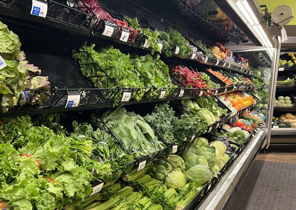 Vegetables and lettuces at a grocery store in Michigan. Michigan health officials say lettuces and salad greens are emerging as a likely source in the nationwide cyclosporiasis outbreak, which has sickened hundreds of people across 31 states. (Photo by Jon King/Michigan Advance)