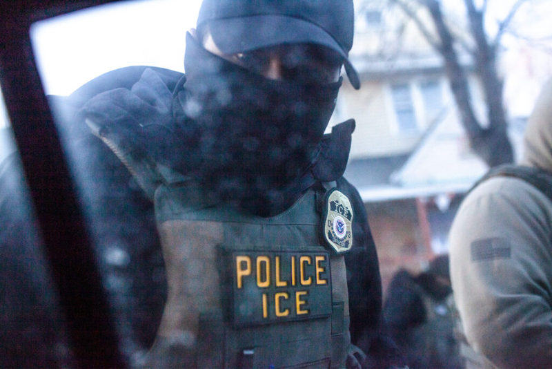 A masked U.S. Immigration and Customs Enforcement agent knocks on a car window in Minnesota on Jan. 12, 2026. (Photo by Nicole Neri/Minnesota Reformer)