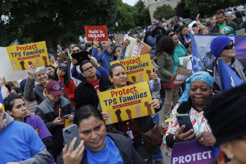 Demonstrators chant and hold signs outside U.S. Supreme Court on April 29, 2026 in Washington, D.C. The court heard arguments challenging the termination of Temporary Protected Status for immigrants. (Photo by Tom Brenner/Getty Images)