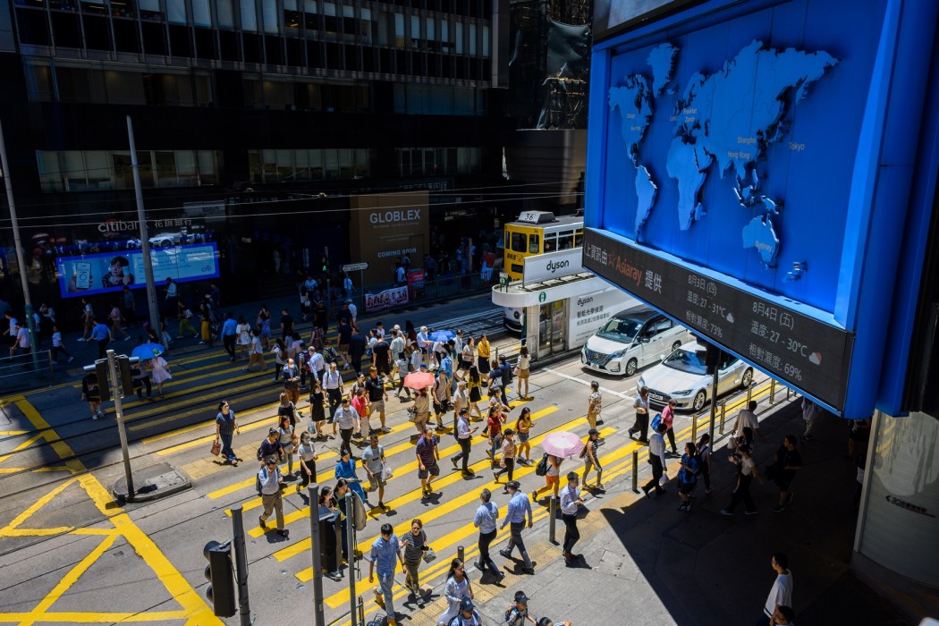 People cross a street in Central district. Photo: Kyle Lam/HKFP.