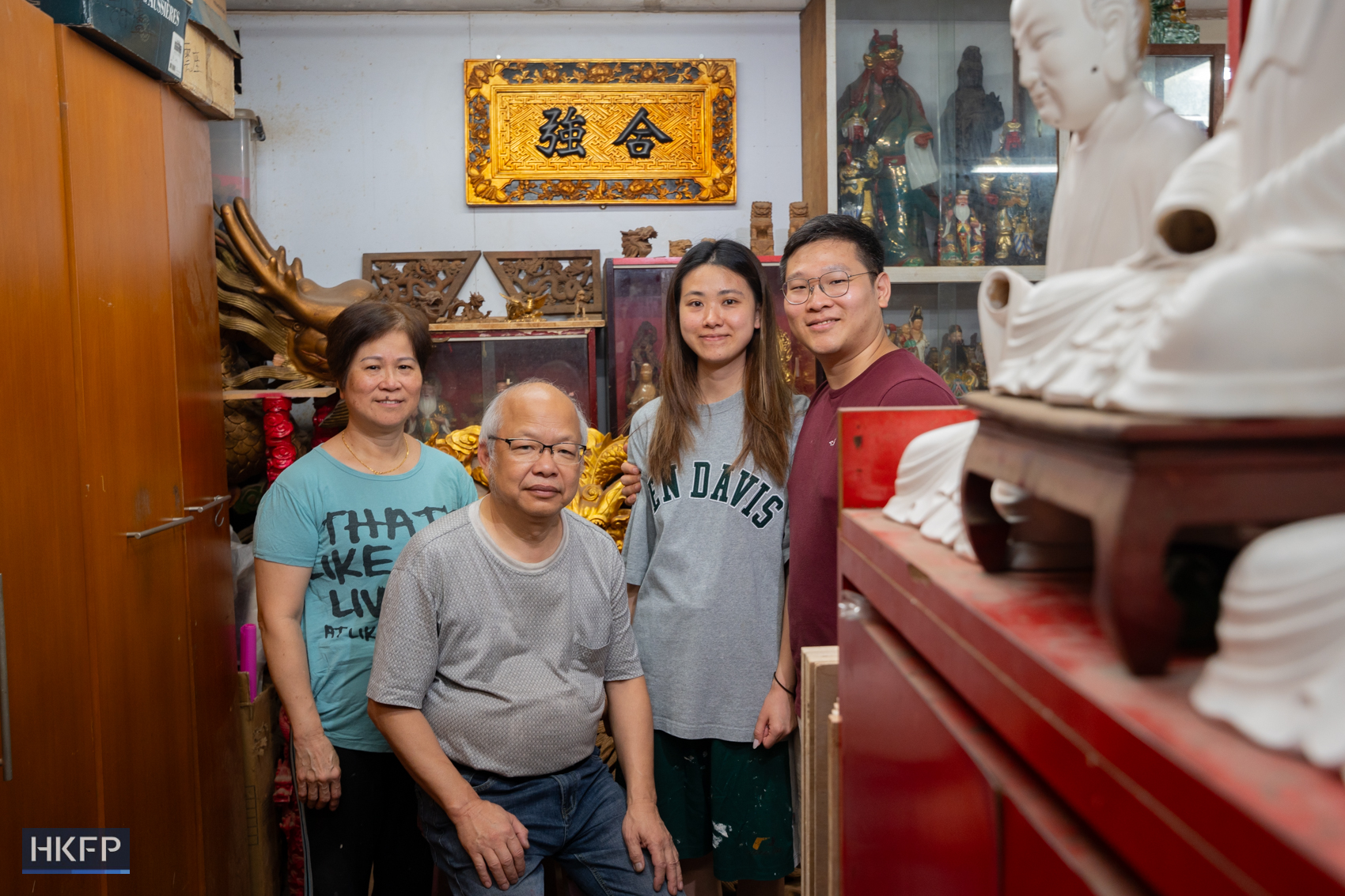 Siu's family pose for photos in an industrial building in Kwai Chung, July 27th, 2026. Photo: Kyle Lam/HKFP.