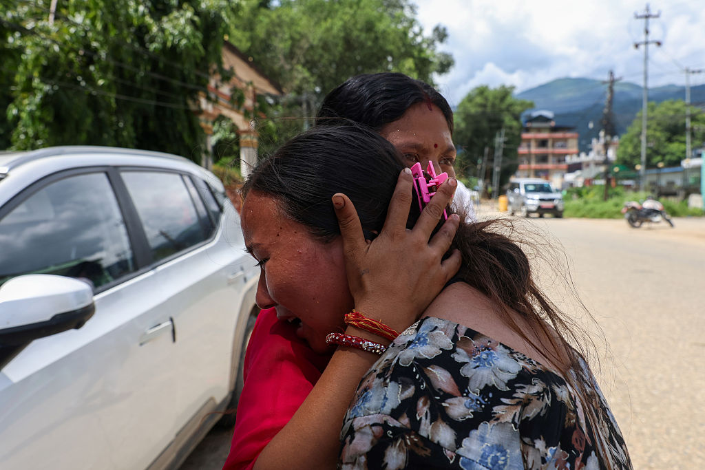 A woman bursts into tears on August 28, 2026, as she awaits news about her missing loved ones, amid the aftermath of landslide and flash floods in areas near the Nepal-China border, in Bidur, Nuwakot, Nepal.
