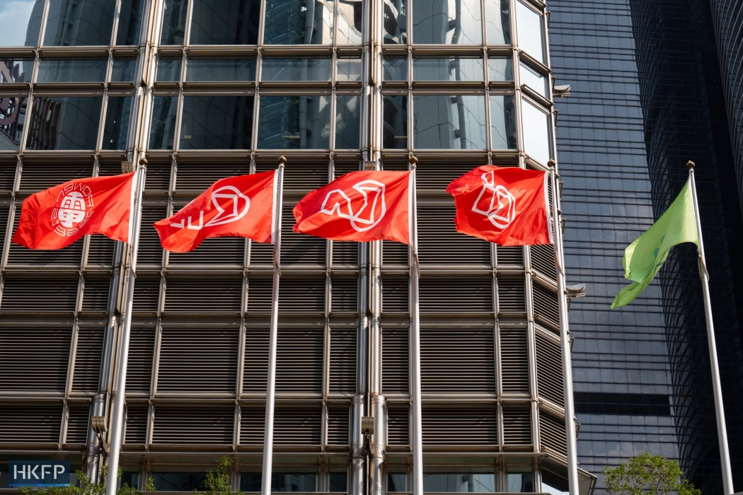 Flags outside Cheung Kong Center, the headquarters of Hong Kong-based conglomerate CK Hutchison Holdings. Photo: Kyle Lam/HKFP.