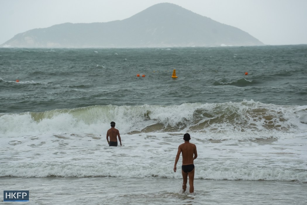 People enter the water at Shek O beach, in Hong Kong, on September 9, 2024. Photo: Kyle Lam/HKFP.