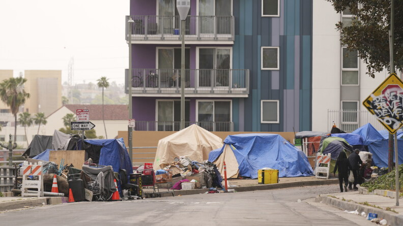 Tents line a sidewalk.