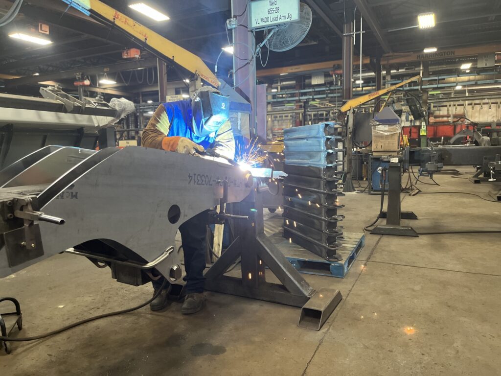 A welder works at a Manitou factory in June 2023 at Madison, South Dakota. Labor shortages in North Dakota and South Dakota could be harbingers of a shortage of young people in coming years. (Photo by Joshua Haiar/South Dakota Searchlight)